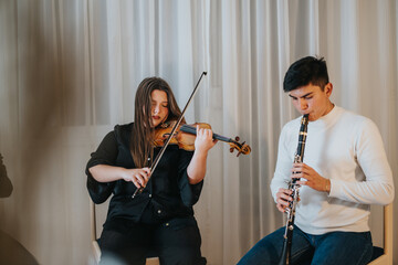 Two artists play the violin and clarinet in a serene and artistic atmosphere. Their performance...