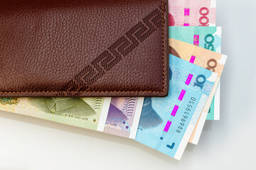 Leather Wallet with Colorful Chinese Yuan Banknotes. Personal Finance Concept.