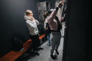 A group of friends in a locker room getting ready for a workout, a moment of preparation and camaraderie. Showcases preparation, friendship, and fitness enthusiasts in an indoor environment.
