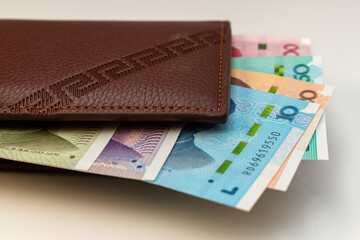 Leather Wallet Filled with Chinese Yuan Banknotes Representing Personal Finance