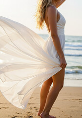 Woman in a flowing white dress enjoying the sunset on a serene beach