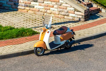 Fotobehang Scooter Small vintage scooter parked at the roadside in Belarus.  © Arkadi