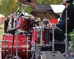 middle aged bearded man on music stage scene. Male drummer artist musician playing the drums with drumsticks. Live music. The drummer plays solo. Rock concert. Band. Belgrad, Serbia