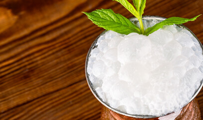 Turkish buttermilk in a copper cup on wooden background. Turkish yogurt drink