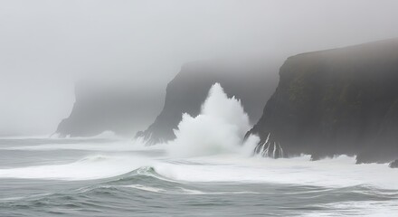 Obraz premium Waves crash against the cliffs in the fog