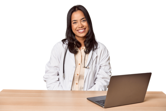 Young Filipino doctor with laptop in studio happy, smiling and cheerful.