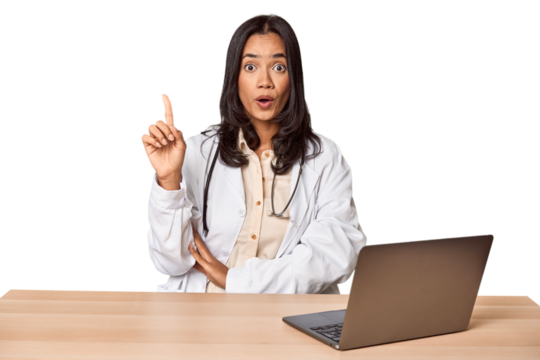 Young Filipino doctor with laptop in studio having some great idea, concept of creativity.