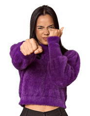Young filipino woman throwing a punch, anger, fighting due to an argument, boxing.