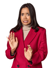 Young filipino woman rejecting someone showing a gesture of disgust.