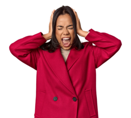 Young filipino woman covering ears with hands trying not to hear too loud sound.