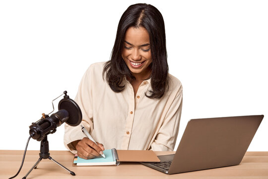Filipino woman podcasting with mic and laptop