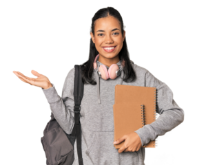 Young Filipino female student with books showing a copy space on a palm and holding another hand on waist.