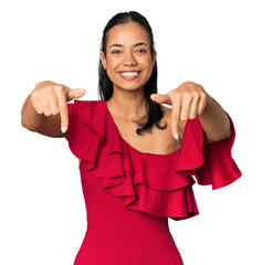 Young Filipino woman in studio points down with fingers, positive feeling.