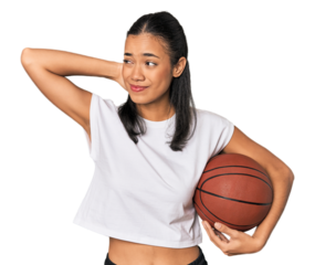 Young Filipino woman with basketball touching back of head, thinking and making a choice.