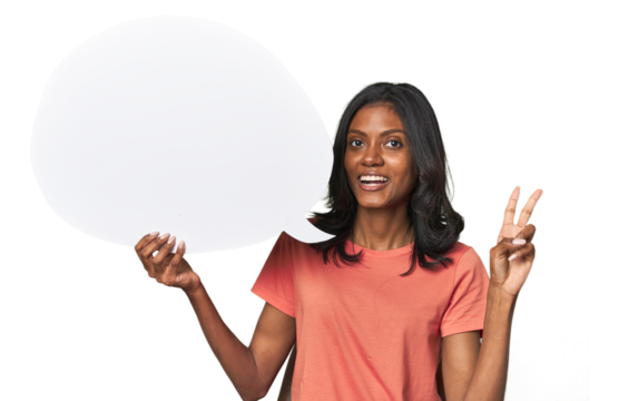 Indian woman with dialogue bubble joyful and carefree showing a peace symbol with fingers.