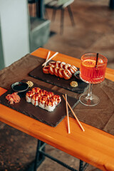 Sushi Rolls and Tempura Served with Cocktail Drink
