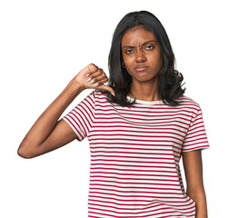 Portrait of a young Indian woman showing thumb down, disappointment concept.