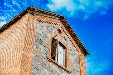 Stone and Brick House with Open Window