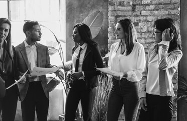 Multiracial people working on financial project - Business meeting, corporate and entrepreneur concept - Soft focus on man face - Black and white editing