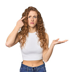 Simple redhead studio portrait suffering a back pain.