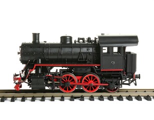 Naklejka premium Black Steam Locomotive Model on Track, Isolated White Background.