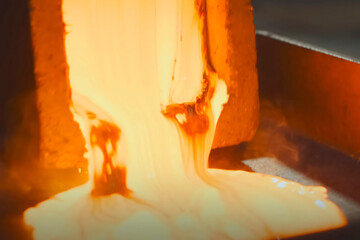 Molten gold pours out of mold
