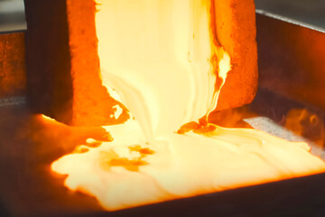 Molten gold pours out of mold