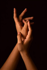 Close-up of elegant hands against a dark background