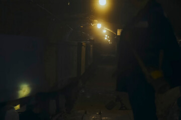 minecarts are driving down the corridor of the gold mine.