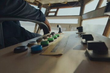 excavator control panel buttons and the operator's hand nearby.