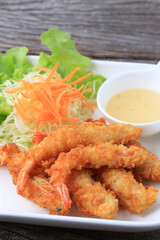 Crispy Batter Fried Prawns garnished with shredded cabbage and carrots, Food photography for use in menus