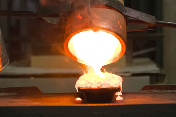 Molten gold pours out of crucible