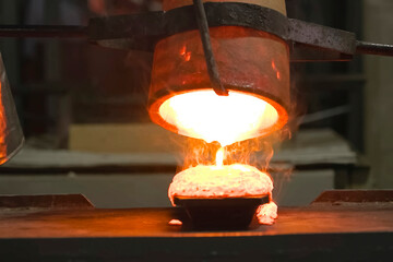 Molten gold pours out of crucible