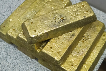 Freshly smelted gold bar raw material condition.