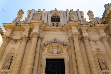 Baroque church facade with columns and sculptures in Lecce