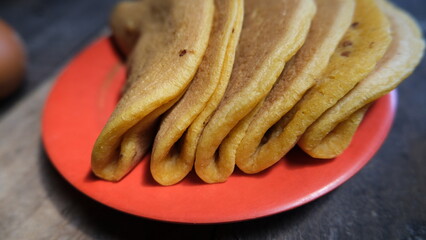 Traditional Indonesian sweet mini martabak on red plate  
