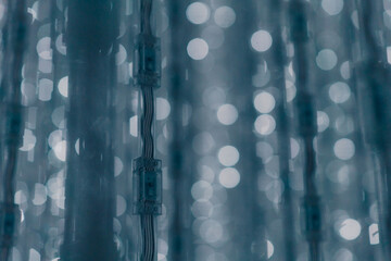 tokyo, japan - Garlands lights white glitter hanging vertical lines rain confetti