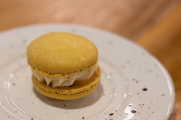 Delicious Yellow Macaron with Cream Filling on a Plate