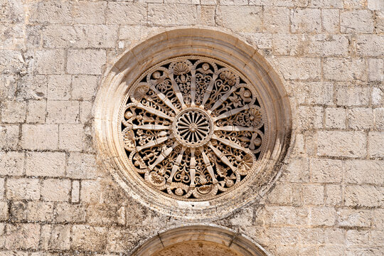Ornate stone rose window with radial tracery pattern