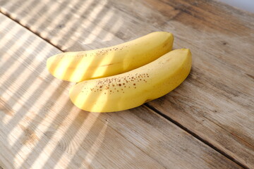 Fresh bananas on wooden table, Ripe yellow bananas, rich in potassium, healthy lifestyle, diet,...