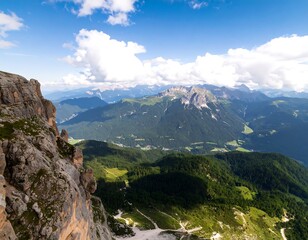 Fototapeta premium Panoramic vista of a rugged mountain range, showcasing lush valleys and a vibrant sky.