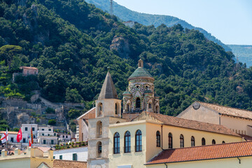 Cathedral dome and bell tower with forested hills behind