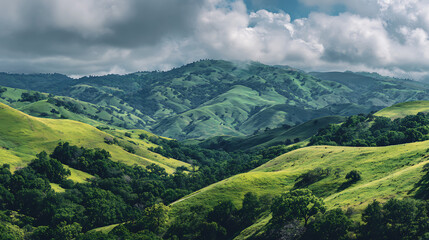 Fototapeta premium Lush green hills under a cloudy sky in a serene landscape during midday