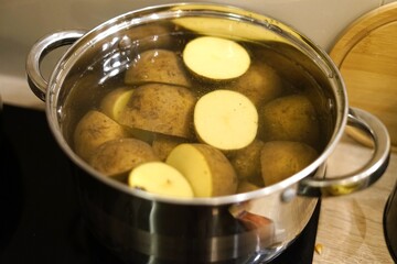 Boiling potatoes with highquality stainless steel cookware making cooking lunch dinner family housewife