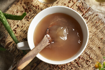 Naklejka na ściany i meble A bowl of homemade flax seed gel - ingredient for natural diy shampoo. Alternative haircare, no poo.