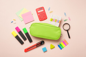 School stationery, school supplies on colored background. Pencil case, notepads, markers, pens and others. Flat lay image.