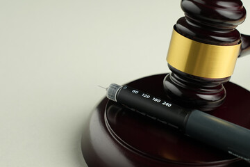 Semaglutide injection pen with judge gavel – legal and ethical debate in medicine