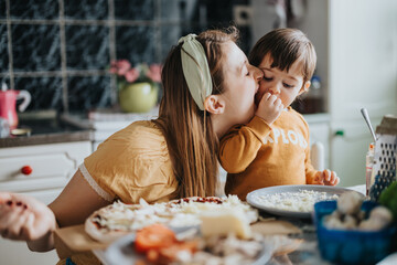 A joyful scene of a mother and her young child cooking together, showcasing love and togetherness, surrounded by fresh ingredients in a home kitchen. A bonding moment filled with family spirit.