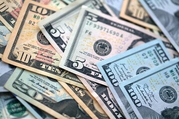 Big amount of different dollar bills close up. Hundred fifty twenty ten and five dollar banknotes