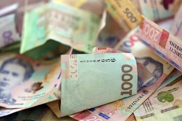 Big amount of Ukrainian hryvnia money bills. Pile of crumpled ukrainian banknotes